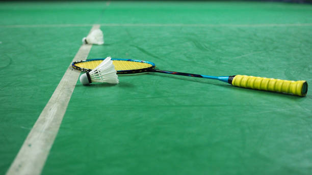istock Badminton racket and shuttlecock inside a badminton court. 1085977452
