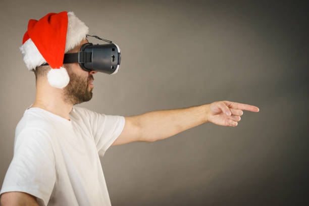 istock Man in virtual reality goggles and santa hat 1085977656