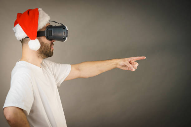 istock Man in virtual reality goggles and santa hat 1085977782
