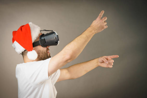 istock Man in virtual reality goggles and santa hat 1085980270