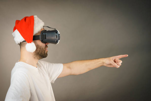 istock Man in virtual reality goggles and santa hat 1085981298