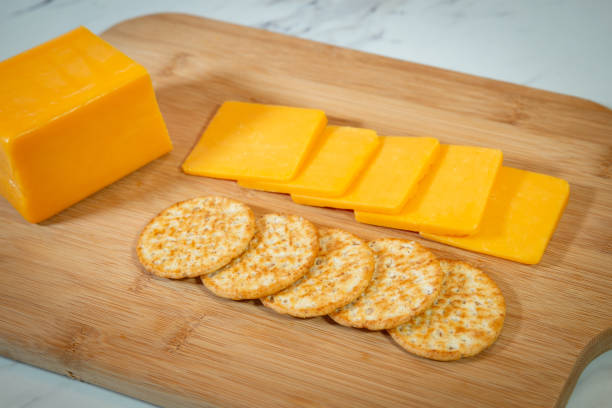 istock Cheese and crackers on a wooden cutting board 1085981354