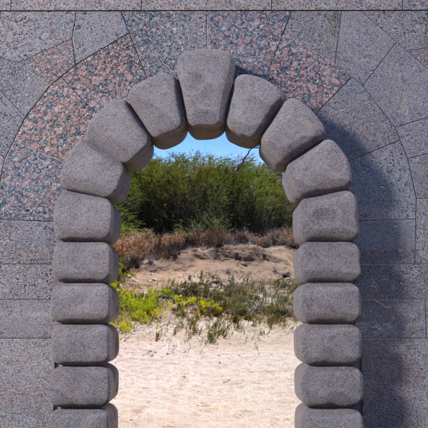 istock Granite gate with wall and sandy landscape 1085981560