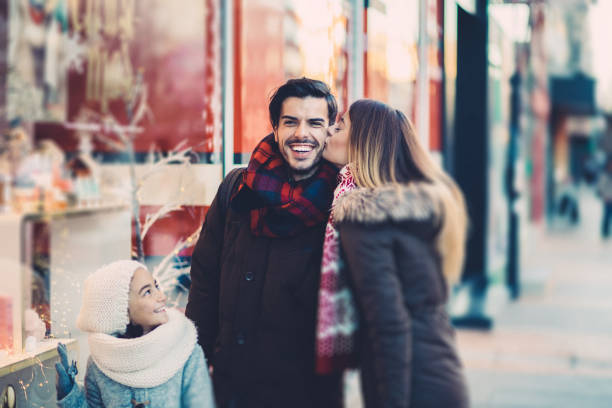 Family Christmas shopping Family shopping Christmas presents together three way kiss stock pictures, royalty-free photos & images