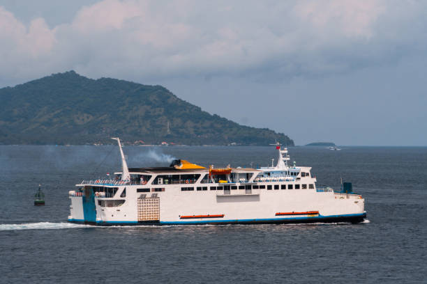istock ferry, Ferry sailing in the ocean against the shore 1085983866