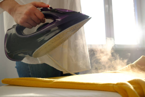 istock Girl ironing clothes 1085985200