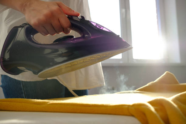 istock Girl ironing clothes 1085985204