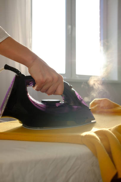 istock Girl ironing clothes 1085985248