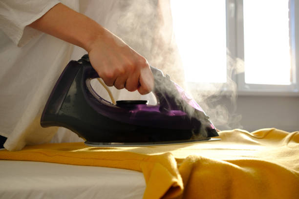 istock Girl ironing clothes 1085985274