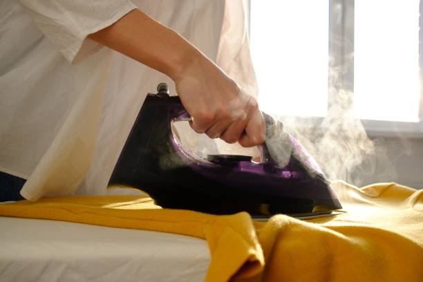 istock Girl ironing clothes 1085985288