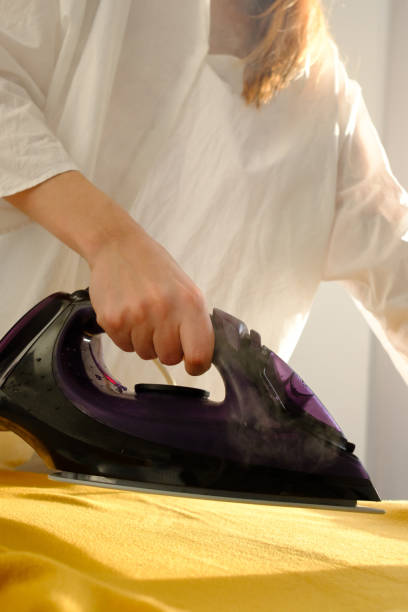 istock Girl ironing clothes 1085985294