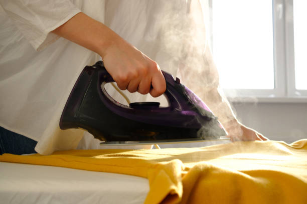 istock Girl ironing clothes 1085985296