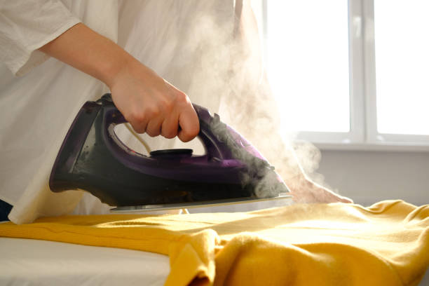 istock Girl ironing clothes 1085985298
