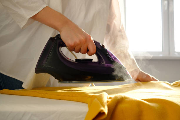 istock Girl ironing clothes 1085985310