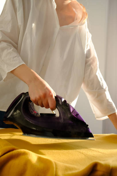 istock Girl ironing clothes 1085985312