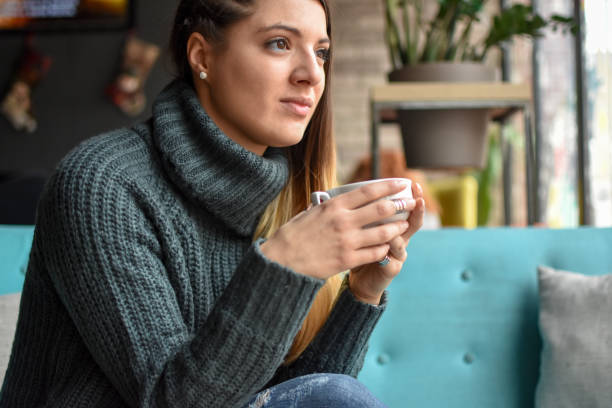 istock Beautiful young woman in cafe 1085985354