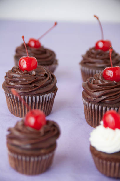 istock Chocolate Cupcakes with Maraschino Cherries 1085988180