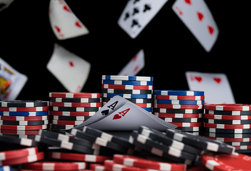 cards and chips for playing poker on the background of falling cards, black background