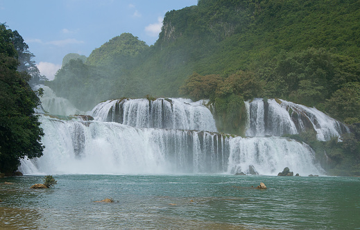 View of the falls from Vietnam during the rainy season when the flow is at its maximum Ban Gioc -Detian Falls is a collective name for two waterfalls on the Quay Son River