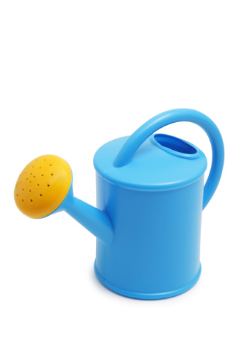 Toy plastic watering can isolated on white