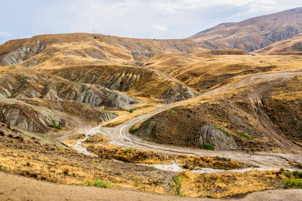istock Dirt mountain road after the rain 1086003640