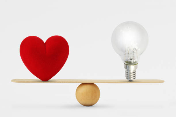 heart and light bulb on scale - concept of balance between heart and brain - sensibility imagens e fotografias de stock