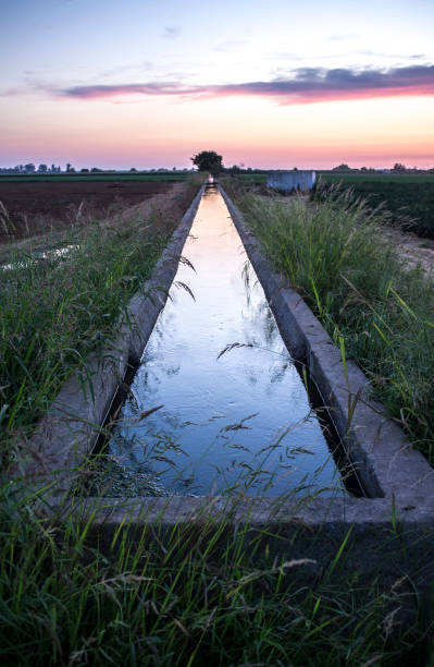 istock Concrete irrigation canal at sunset 1086011470
