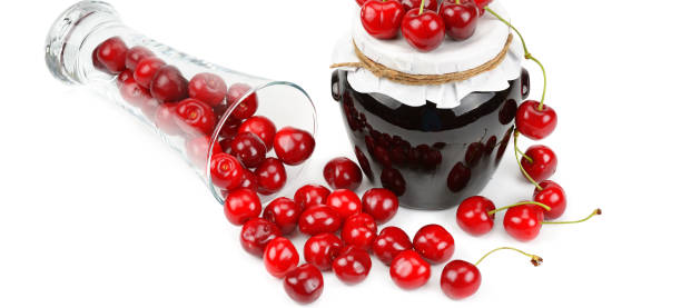 istock Cherries and jars of jam isolated on a white background. 1086015458