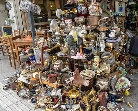 Athens, Greece - October 19, 2018: A pile of trinkets and antiques for sale at a marketplace in the Monastiraki neighborhood, known for its antique shopping and flea markets.