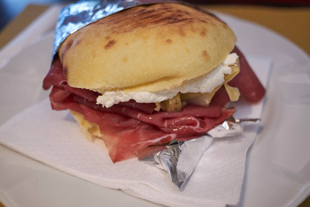 istock Puccia with parma ham, cheese and artichoke 1086020632