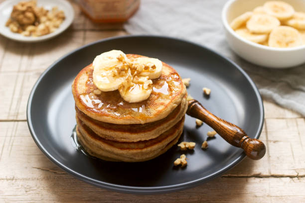 istock Pancakes with banana, nuts and honey, served with tea. Rustic style. 1086021852