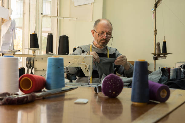 istock Portrait of tailor while working on sewing machine 1086024380