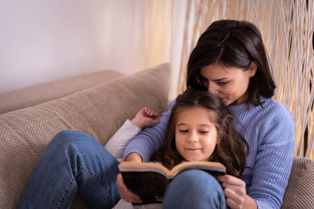 istock Mother and daughter reading together 1086025278
