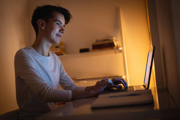 istock Teenage boy learning at night 1086032318