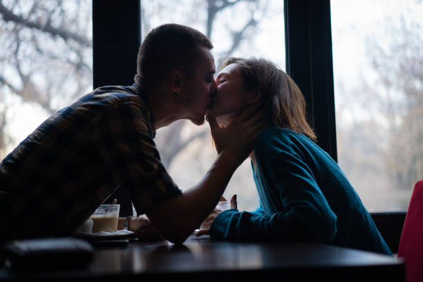 Romantic couple kissing in a cafe