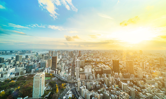Asia Business concept for real estate and corporate construction - panoramic urban city skyline aerial view under bright blue sky and sun in Tokyo, Japan