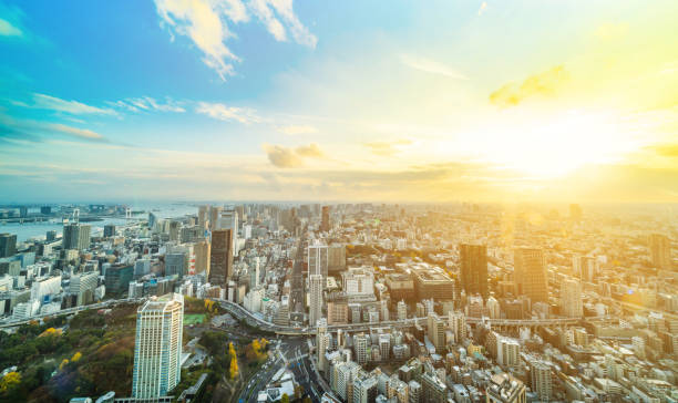 urban city skyline aerial view in Tokyo, Japan Asia Business concept for real estate and corporate construction - panoramic urban city skyline aerial view under bright blue sky and sun in Tokyo, Japan tokyo japan stock pictures, royalty-free photos & images