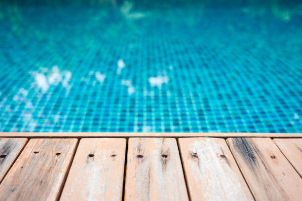 istock Swimming pool and wooden deck ideal for backgrounds 1086048426