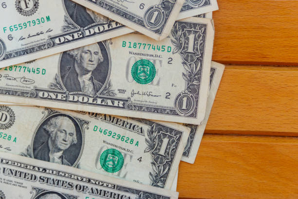 istock American one dollar bills on wooden background. Top view, copy space 1086057512