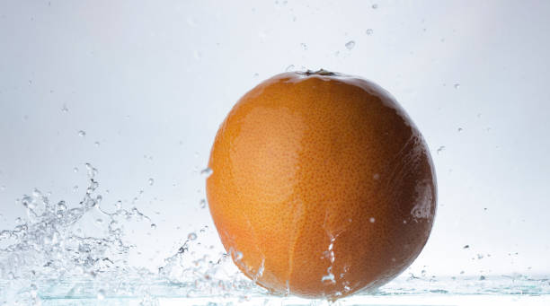 istock Whole large mandarin thrown and splashes of water 1086060550