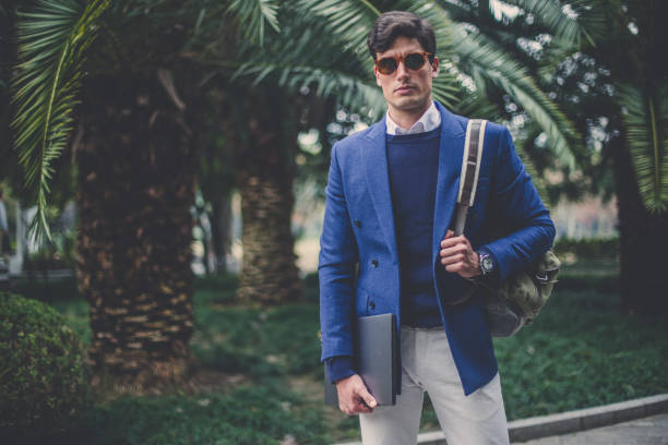 istock Stylish tourist holding backpack and laptop 1086063672