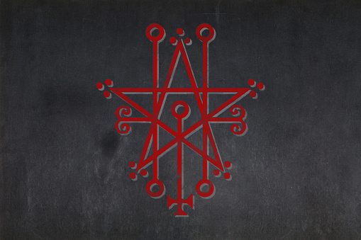 Blackboard with a the Sigil of Astaroth drawn in the middle.