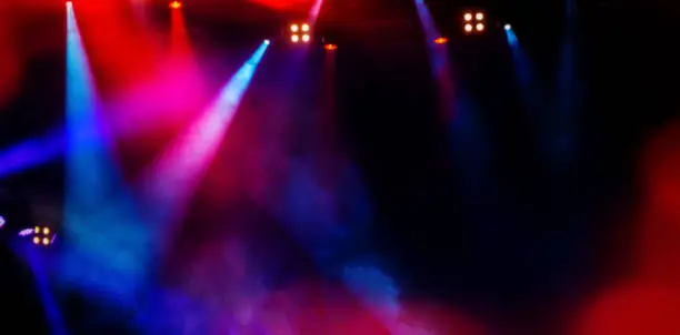 Photo of floodlights scene during a rock concert. Blurred background.