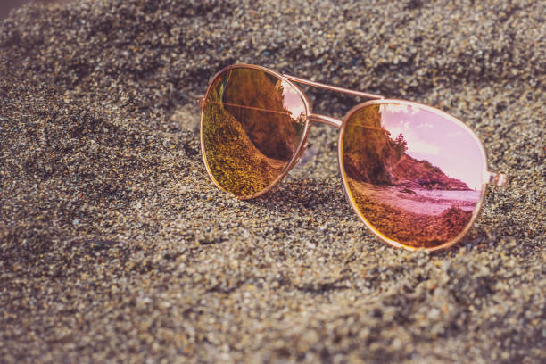 istock Sunglasses at the beach with sea reflection. 1086081084
