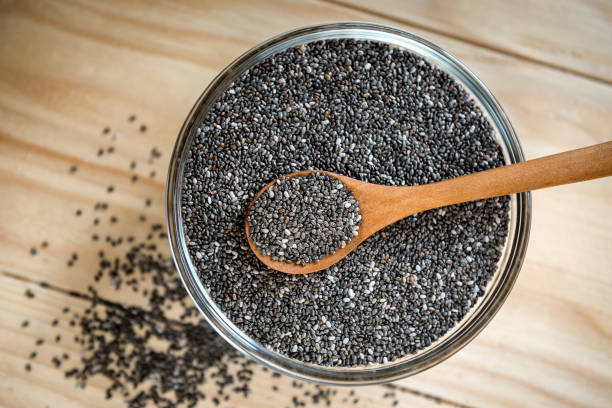 istock Raw organic black chia seeds on wooden spoon 1086082142