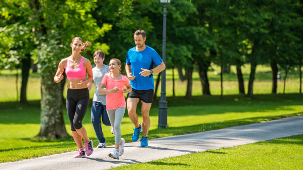 istock Family jogging in the park 1086089250