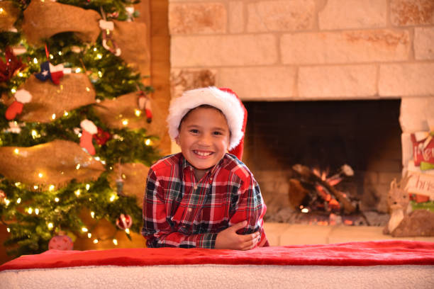 istock young boy  celebrating Christmas in a cozy cabin 1086089656