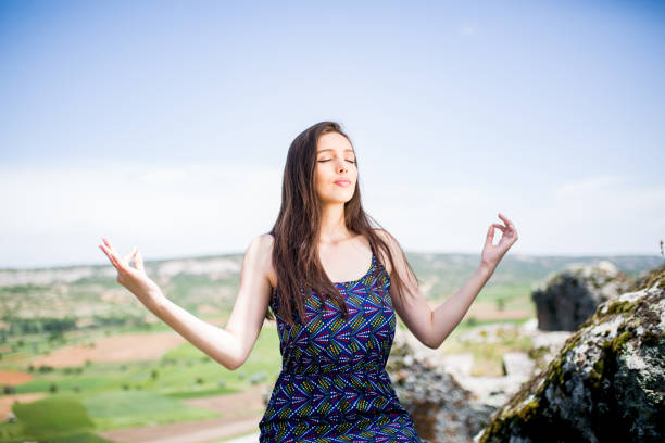 istock woman meditating in nature 1086089850
