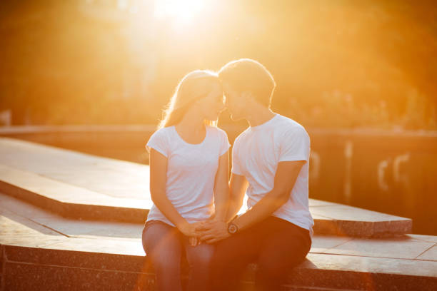 couple in love enjoying moments during sunset - silhouette kissing park sunset imagens e fotografias de stock