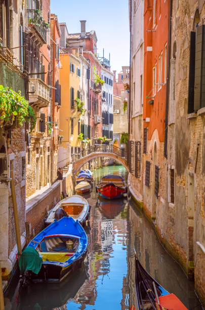 Traditional narrow canal with gondolas in Venice, Italy Traditional narrow canal with gondolas in Venice, Italy gondola traditional boat photos stock pictures, royalty-free photos & images